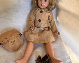 14" Effanbee Doll with WAC uniform (original military costume and cap, olive drab stocking - one is missing - and leather shoes.) Composition socket head, painted blue eyes, fringed lashes, lightly feathered brows, closed mouth with rose-bud shaped lips, blonde mohair wig, 5 piece body. Marks: Suzanne Effanbee Made in USA. Circa 1940.