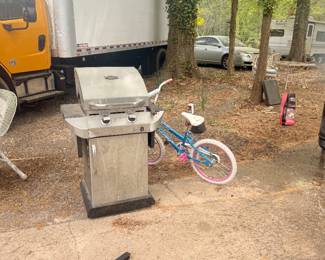 Barbecue grill and little girls bike
