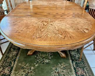 Vintage oak dining table and six carved back chairs.  Area rug also for sale.