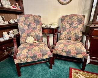 Chippendale style arm chairs with floral upholstery.