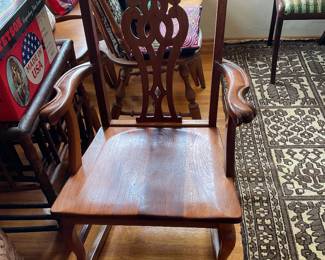 Rocking chair with lovely wood detail on back and curved arm handles solid wood note. Also scroll on back top sides.