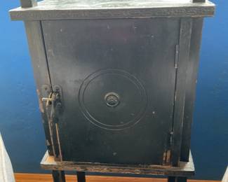 Humidor stand shown between two gray channel back chairs