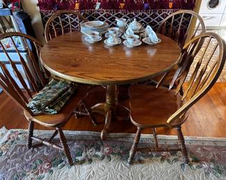 41 inch diameter round table with laminate top so easy to keep clean with four chairs on center pedestal base