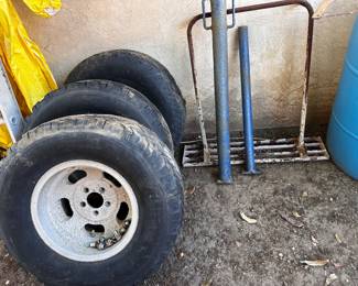 Set of trailer tires with a spare post hole punches and cement tapper