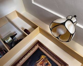 Hanging light is yellow and cream, slag glass with detailed brass 