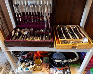 Sets of silver plate flatware two different sets on left stainless set on right