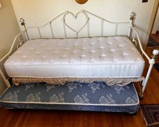Daybed uncovered with two mattresses one on trundle below both twin size