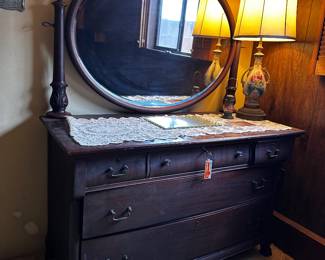 Antique dresser with three top drawers and two lower drawers all that lock key included large oval beveled mirror top is 51 inches wide and 22 inches deep