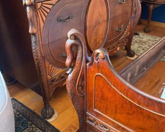 Detail of the Swan carving on the footboard of the bed and the lower section of the chiffonier chest and the dresser