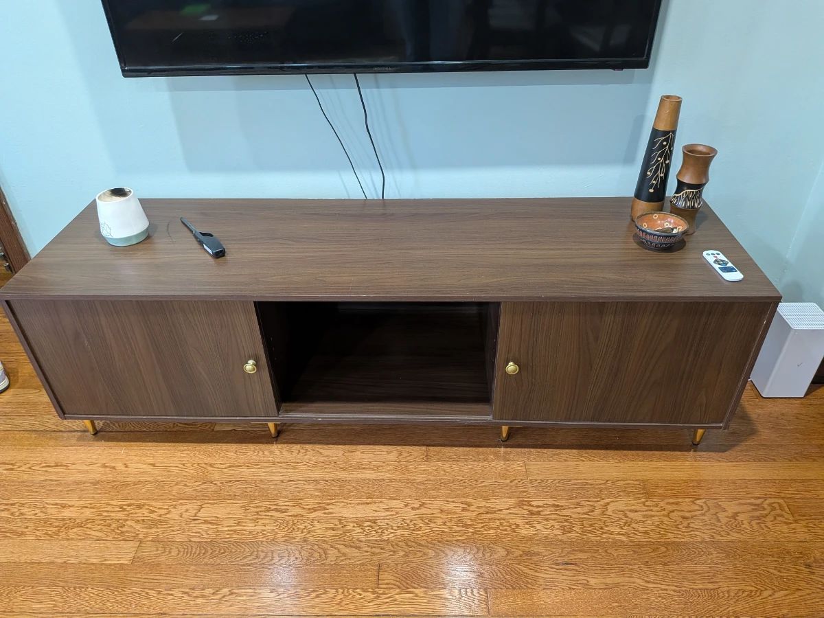 long TV console with sliding doors and gold feet