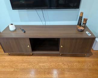 long TV console with sliding doors and gold feet