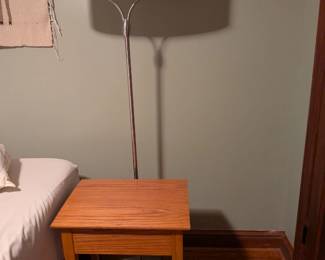 lamp with two bulbs and small side table or nightstand