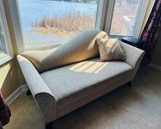 Beige upholstered chaise  lounge with subtle swirl design