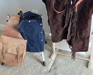 Suede chaps, saddlebags , Calvin Klein denim vest , horse riding spurs 