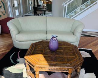 Post modern light colored curved couch ( can't be picked up until after the house sells), octagonal vintage oak coffee table