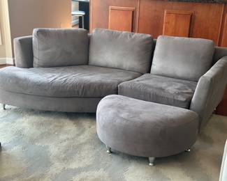 Gray velvet curved sectional with matching ottoman possibly by Roche Bobois ( this item can be purchased but not picked up until after the house sells) 