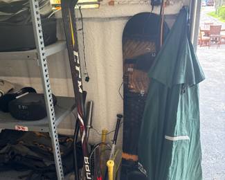 Hockey sticks, tennis racket, outdoor patio umbrella