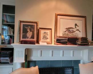 Framed artwork, antique books, and tabletop books