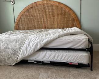 B11 - $250. Wicker Headboard used as a day bed. Twin size mattress with pop up trundle that makes it king sized. 