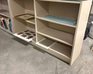 B79 - $30. Bookcase with glass top. 1 shelf is adjustable other shelves are fixed. Measures 48" x 12" x 29.5" tall. 