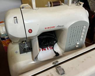 B87 - $30. Singer Athena Sewing Machine. Untested. Has plug and pedal.  It has been sitting in the garage and needs cleaned. 