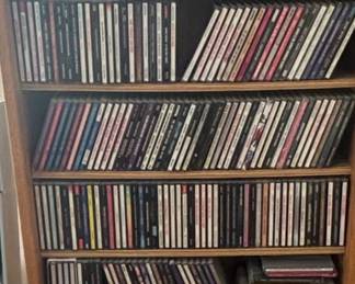 Assorted CD Collection in Wooden Shelf
