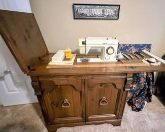 White brand sewing machine and cabinet with storage. Comes with custom made topper.