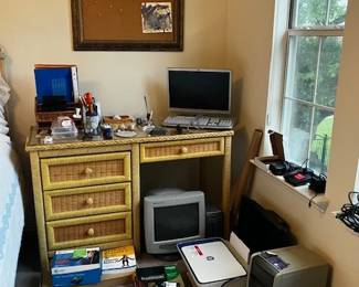Wicker desk, lots of electronics/IT things
