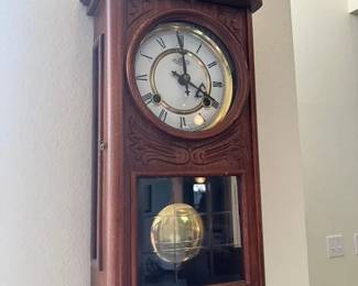 Antique hanging clock. Keeps good time and chimes.