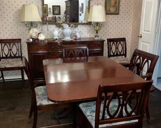 Mahogony dining table with 6  chairs, one arm.  Gilt mirror, buffet. 