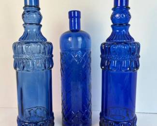 212 triooftalldarkblueglassbottles