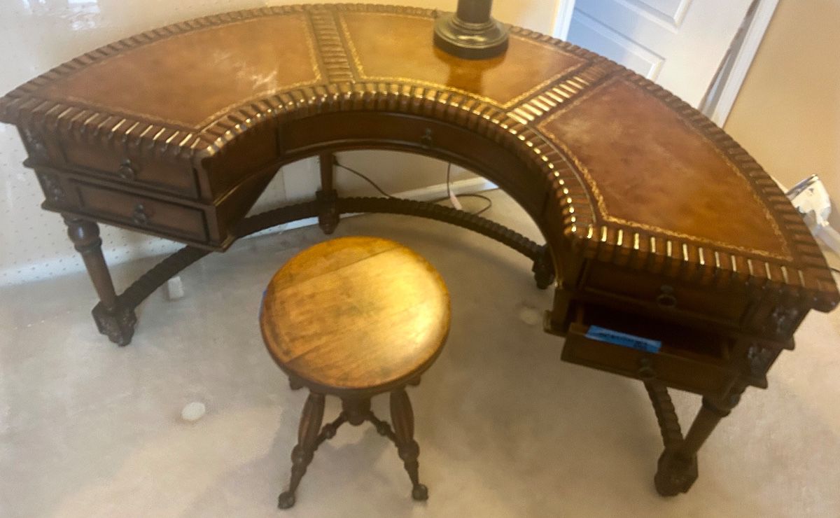 Vntg Horseshoe shaped, carved Wood leather topped with grommet accents desk 60”w x 17.5dx 30”h $950; antique swivel seat carved wood legs w/ Clawfoot legs with glass ball feet $145