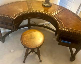 Vntg Horseshoe shaped, carved Wood leather topped with grommet accents desk 60”w x 17.5dx 30”h $950; antique swivel seat carved wood legs w/ Clawfoot legs with glass ball feet $145