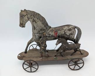 Tin toy horse with boy and foal on wheels