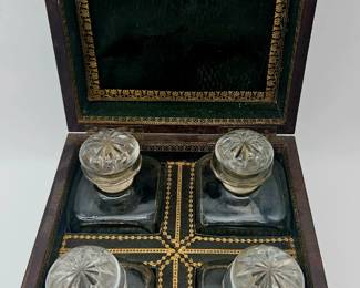Beautiful box with green leather and gilt stamped lining with smaller set of 4 decanters.  Complete and in amazing condition.