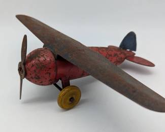 Tin toy airplane with wooden wheels