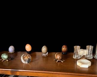 A collection of marble eggs and paper weights