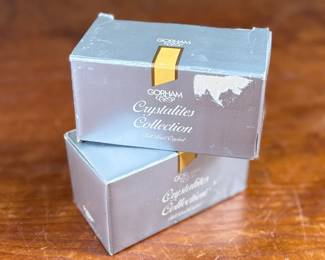 Two Gorham Crystalites Collection swirl candleholders made of lead crystal. Packaged in the original boxes, which show signs of wear and damage. The candleholders depict a modern swirl design and are in good condition with no visible chips or cracks.