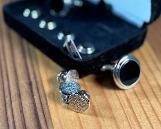 This lot features a Jonathan Wachtel onyx and silver cufflink and stud set, perfect for formal occasions.