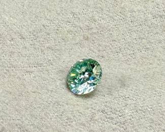 This lot features a large 3.50 carats blue/green moissanite gem from Brazil.