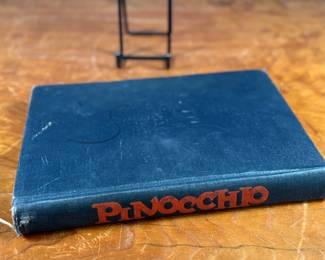 The Adventures of Pinocchio by C. Collodi, printed in Italy by R. Bemporad & Son. This is the third printing of the edition in English text, featuring illustrations in color by Attilio Mussino. Hardcover with a dark blue cover, red spine lettering, and a prominent illustrated design. Published in 1929 by The Macmillan Company. Includes vivid illustrations and period typography.