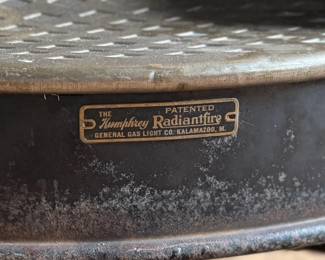 Humphrey Radiantfire No. 20 gas heater by the General Gas Light Co., Kalamazoo, MI. Crafted from cast iron, featuring intricate detailing and the signature model plate. Ornamental design with original patina and wear consistent with age. Includes decorative elements and vented grate. Ideal for collectors or display. Measures, 22” H x 19” W x 11” D.