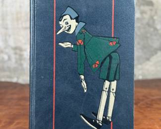 The Adventures of Pinocchio by C. Collodi, printed in Italy by R. Bemporad & Son. This is the third printing of the edition in English text, featuring illustrations in color by Attilio Mussino. Hardcover with a dark blue cover, red spine lettering, and a prominent illustrated design. Published in 1929 by The Macmillan Company. Includes vivid illustrations and period typography.