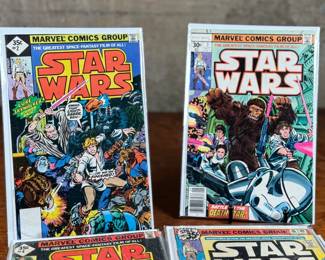 Marvel Star Wars comic books, including numerous issues from the original 1977-1986 series. Covers feature iconic characters such as Darth Vader, Luke Skywalker, Chewbacca, and other figures from the Star Wars universe. Stored in protective sleeves, overall condition appears fair to good for comic book enthusiasts. Fifteen (15) comics total.