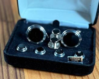 This lot features a Jonathan Wachtel onyx and silver cufflink and stud set, perfect for formal occasions.