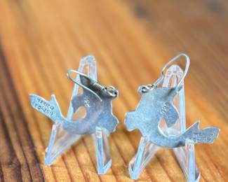 This lot features a pair of stunning vintage Taxco silver "fish" earrings with inlaid malachite.