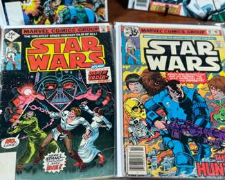 Marvel Star Wars comic books, including numerous issues from the original 1977-1986 series. Covers feature iconic characters such as Darth Vader, Luke Skywalker, Chewbacca, and other figures from the Star Wars universe. Stored in protective sleeves, overall condition appears fair to good for comic book enthusiasts. Fifteen (15) comics total.