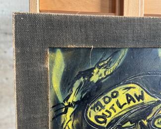 Media artwork on board depicting a skull wearing a hat with ‘100 Outlaw’ written on it. The piece features dark tones accented with striking yellow highlights. There is a gun and a bird incorporated into the imagery. The frame has wear at the edges, and the artist’s signature is present in the lower right corner. Mounted without glass covering and measures, 30” H x 24” W.
