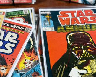 Marvel Star Wars comic books, including numerous issues from the original 1977-1986 series. Covers feature iconic characters such as Darth Vader, Luke Skywalker, Chewbacca, and other figures from the Star Wars universe. Stored in protective sleeves, overall condition appears fair to good for comic book enthusiasts. Fifteen (15) comics total.