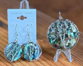 This lot features a set of sterling silver earrings and pendant featuring abalone in excellent condition.